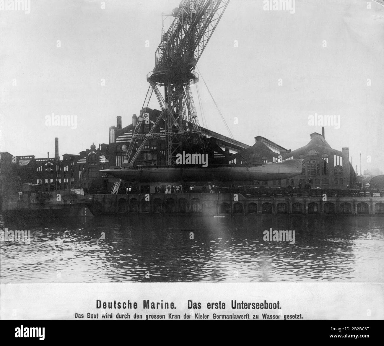 The first German submarine is put into the water by a crane in the Germaniawerft in Kiel. Stock Photo