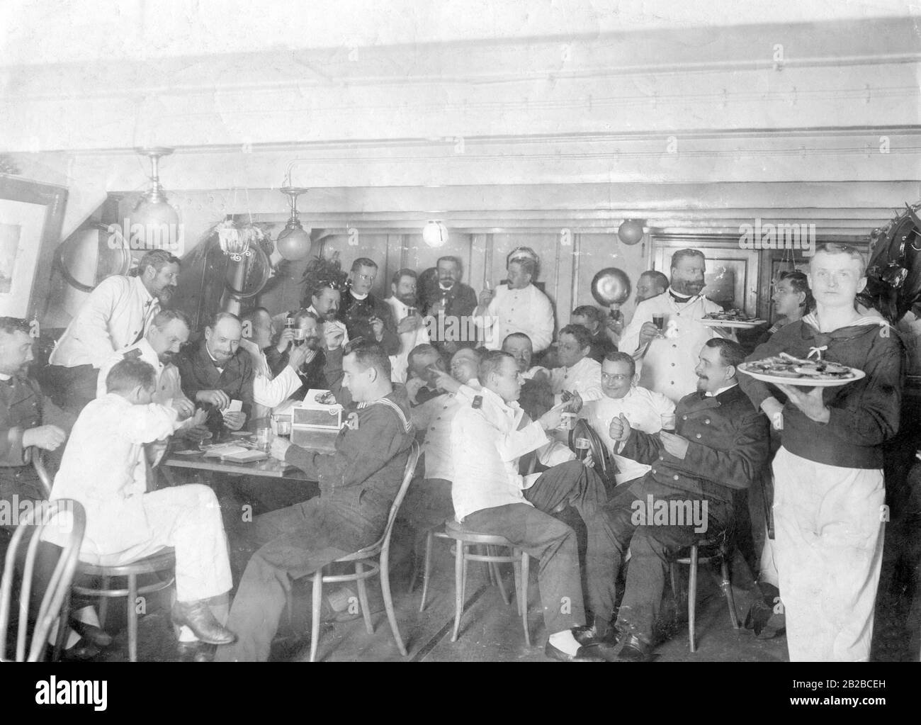 A birthday party of deck officers of the German High Seas Fleet in the officers' mess, where crew ratings are assigned. Among the traditional naval officers the class differences were especially emphasized. This led to a lot of resentment on board and from here started the first refusals to obey orders, which resulted in the sailor's mutiny in 1918. Stock Photo