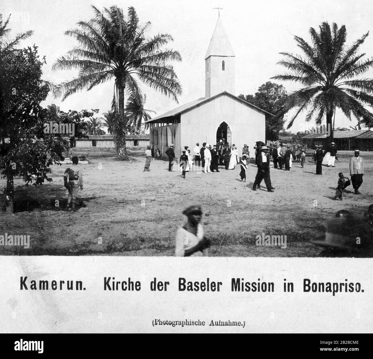 Church of the Basel Mission in the Bonapriso district of today's Douala. Believers are coming out of the church. Stock Photo