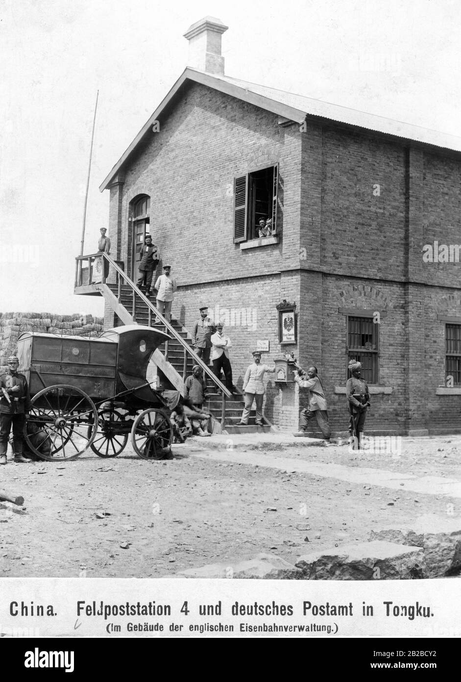 The German Feldpoststation 4 (field post station) and the German post office set up in Tongku in the building of the British railway administration. A German and an Indian military post secure the field post station against Chinese raids during the Boxer uprising. Undated photo. Stock Photo