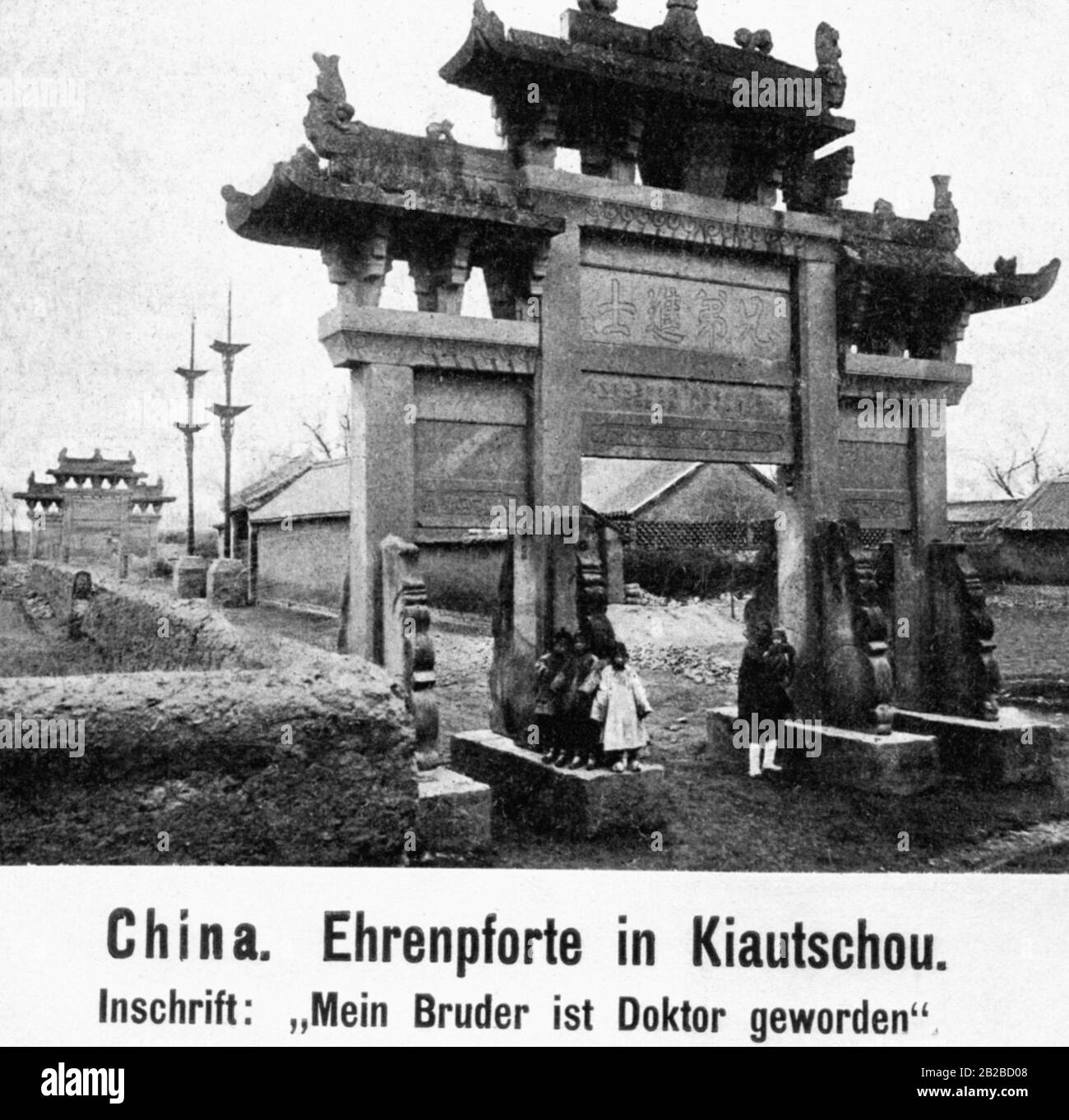 Children in front of the honorary entrance in Jiaozhou in Qingdao, which was built in honor of two brothers who both achieved the highest academic degree in the traditional Chinese examination, the Jinshi degree, which corresponds to the doctorate. Undated photograph. Stock Photo