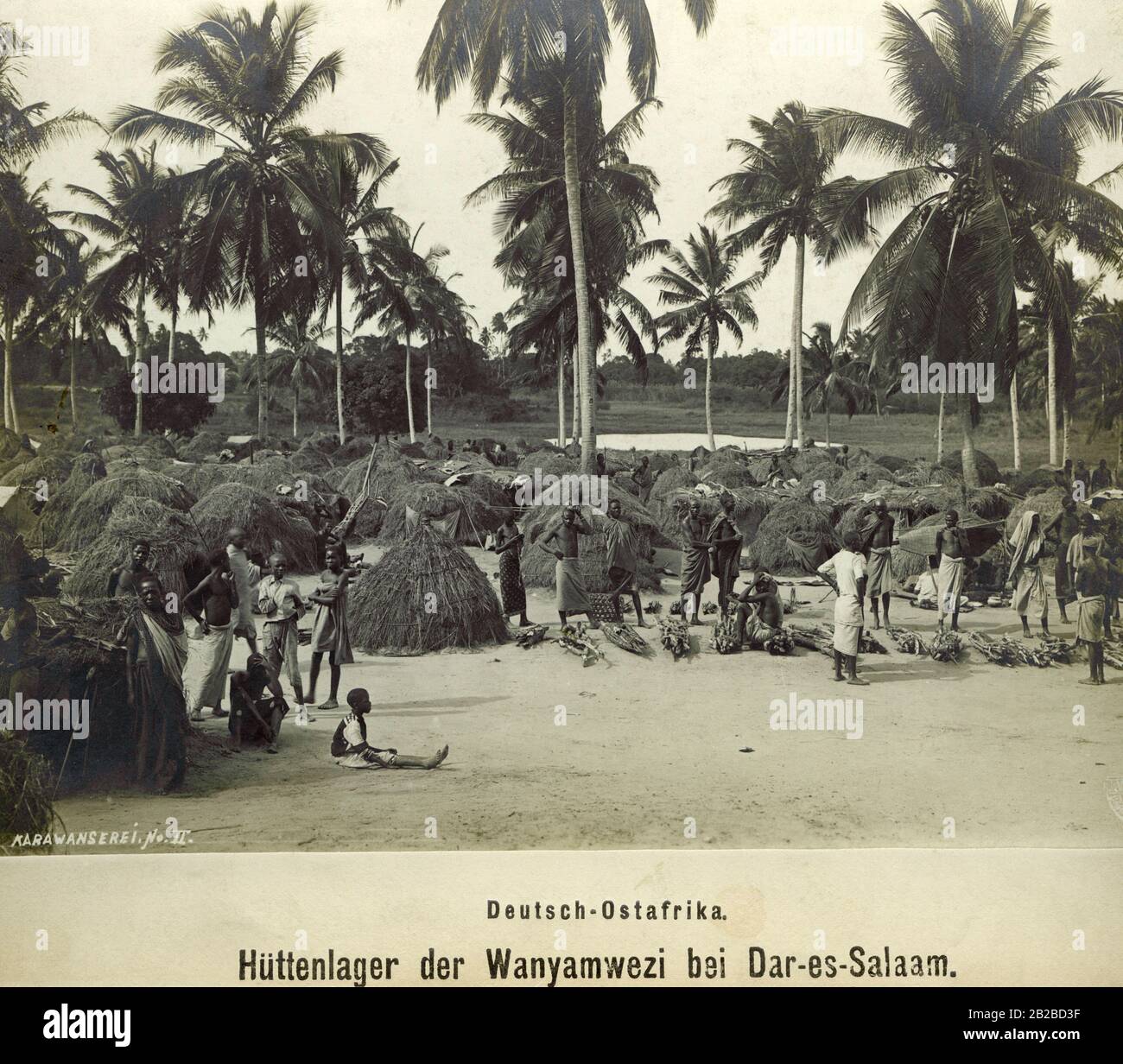 The hut camp of natives from the tribe of Wanyamwezi in front of the capital of German East Africa Dar es Salaam. Stock Photo