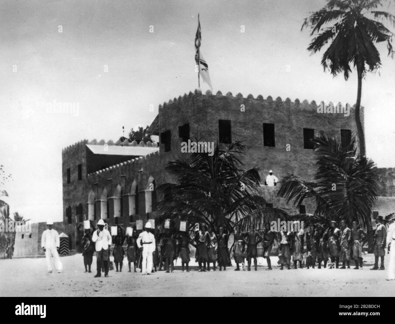 Dr. Carl Peters, one of the founders of the German colony in East Africa, in front of the fort for the first German Schutztruppe in Kilwa. The German Reich's flag is already blowing on the fortress. The photo is undated. Stock Photo