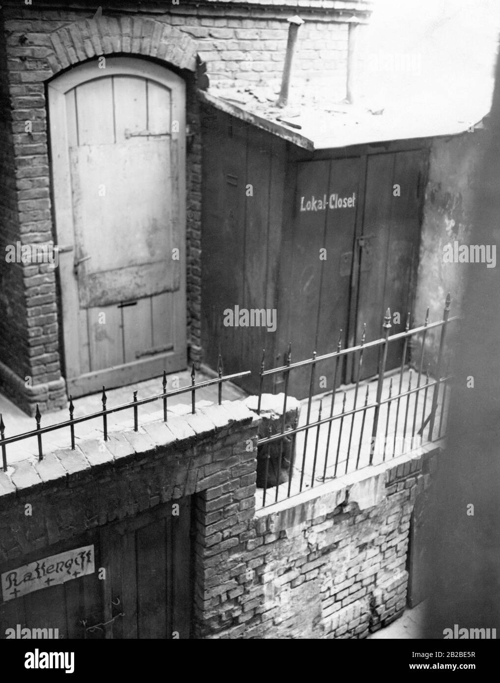 Courtyard of the house at Linienstrasse 29, a tenement in Berlin. The picture shows a communal toilet in the corridor. The photograph was taken shortly before the demolition of the house. The photo is undated. Stock Photo