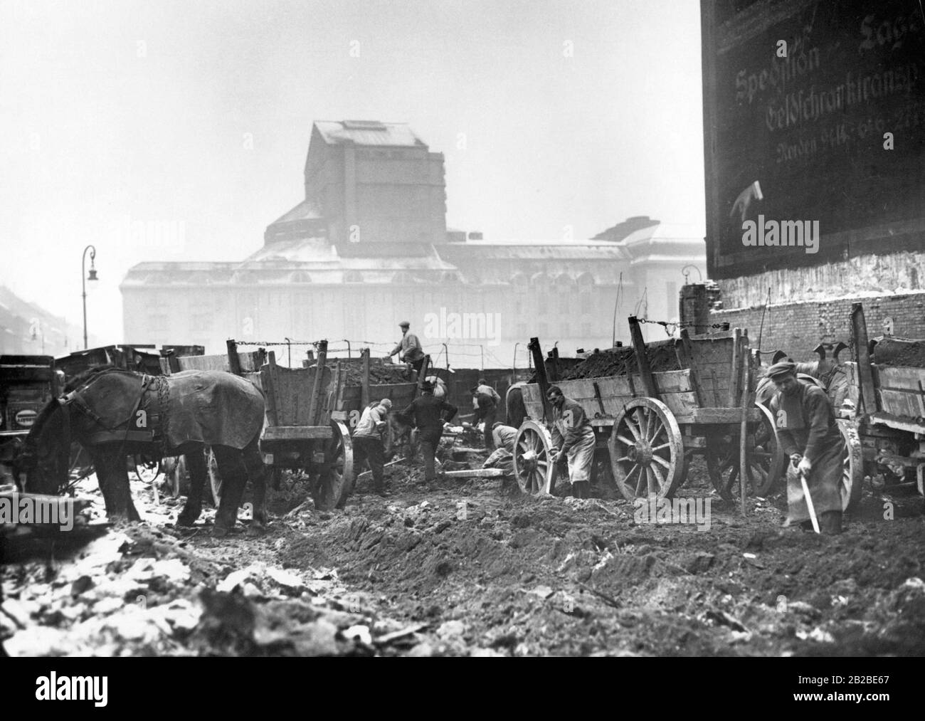 Demolition of the former slum area, the Scheunenviertel, in Berlin. The district was fiercely contested during the street fighting in 1919. The picture shows construction worker loading the first demolition ruins on horse-drawn car. Stock Photo