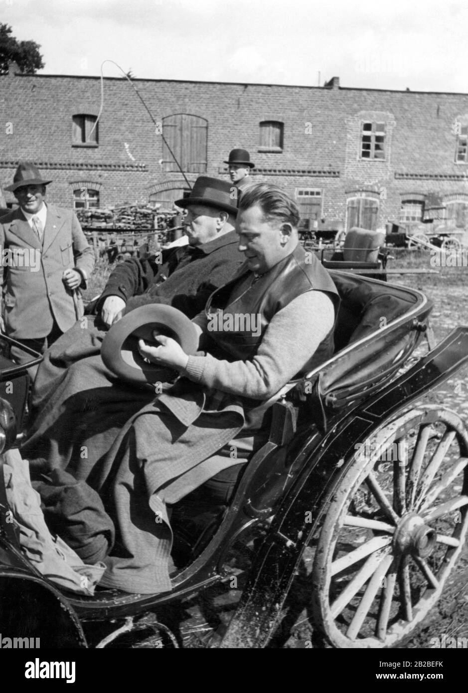 Paul von Hindenburg and Hermann Goeriung are sitting in civilian clothes in a coach. In the background, the barn of Neudeck manor in West Prussia. Undated photo, approx. 1934. Stock Photo