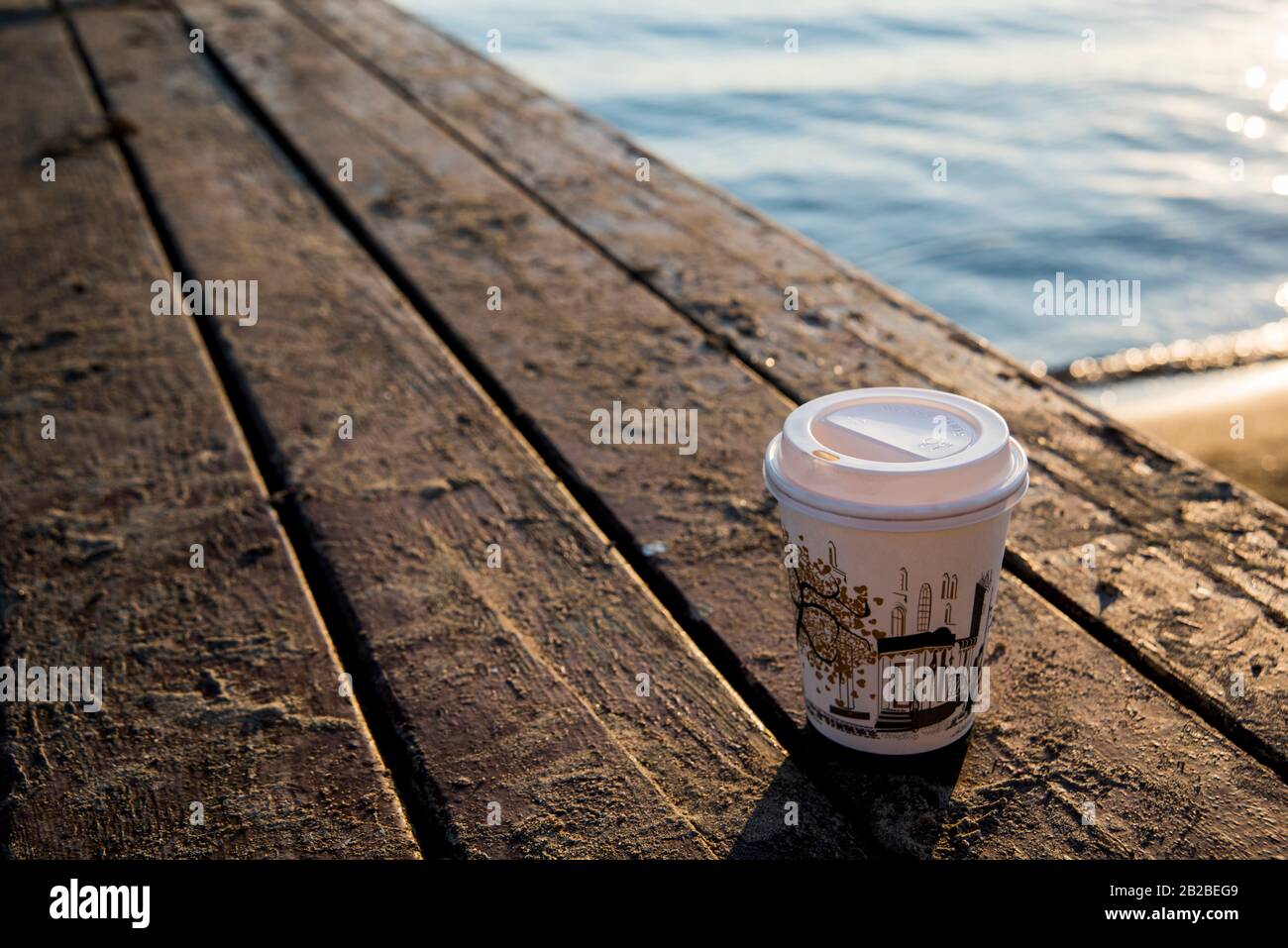 take away coffee cup on the beach Stock Photo