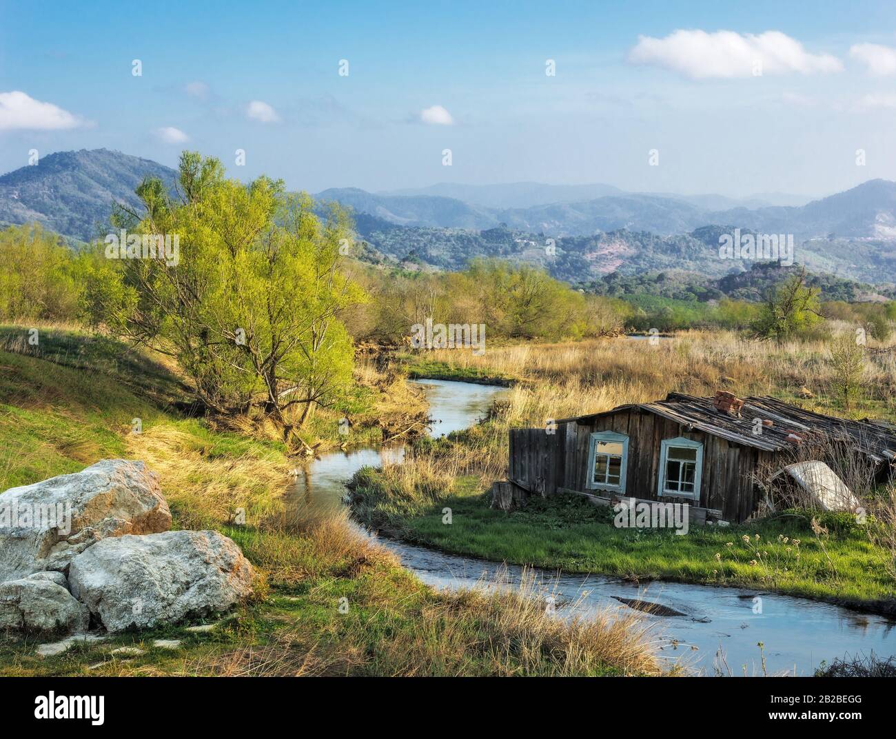 Landscape with a village house on the river bank Stock Photo - Alamy