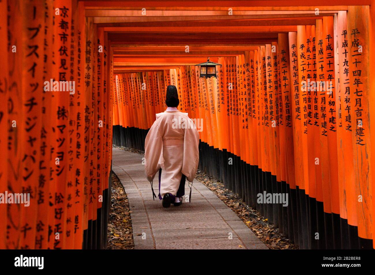 Japanese Priest Walking Up Hill In Kyoto Most Famous Shrine Fushimi Inari Shrine Honshu Japan Asia Stock Photo Alamy