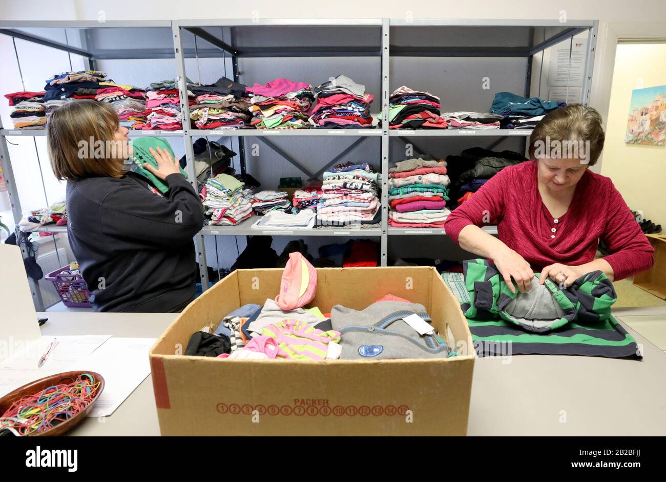 Rostock, Germany. 25th Feb, 2020. Angela Becker (l-r) and Marlis Müller sort laundry items delivered to the clothing store of the German Red Cross DRK and prepare them for sale. About 1100 people come to the clothing store of the Hanseatic city every month. There are 39 DRK dressing rooms nationwide. Credit: Bernd Wüstneck/dpa-Zentralbild/dpa/Alamy Live News Stock Photo