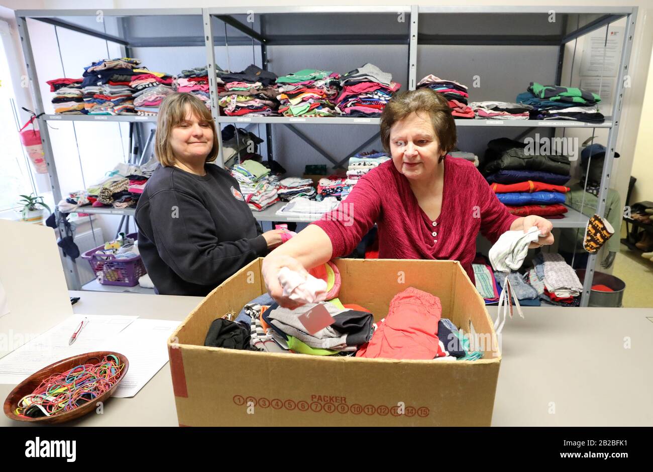 Rostock, Germany. 25th Feb, 2020. Angela Becker (l-r) and Marlis Müller sort laundry items delivered to the clothing store of the German Red Cross DRK and prepare them for sale. About 1100 people come to the clothing store of the Hanseatic city every month. There are 39 DRK dressing rooms nationwide. Credit: Bernd Wüstneck/dpa-Zentralbild/dpa/Alamy Live News Stock Photo