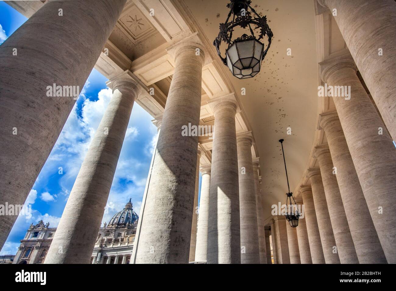 View through the colonnades at St. Peter's Square to St. Peter's Basilica in Rome Lazio Italy Stock Photo