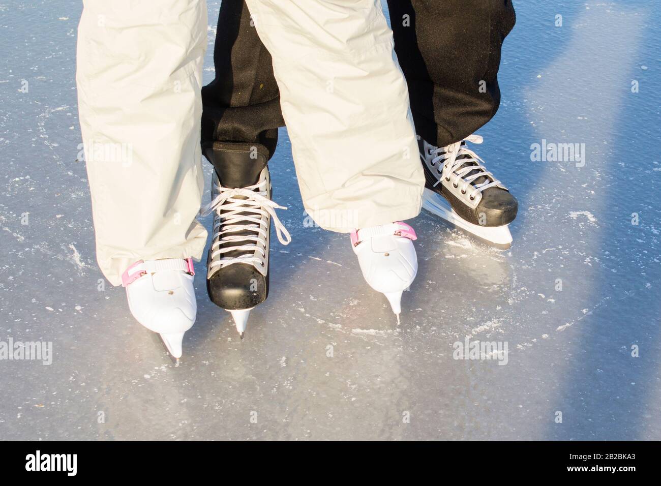 Man's hockey skates and women's figure skates Stock Photo Alamy