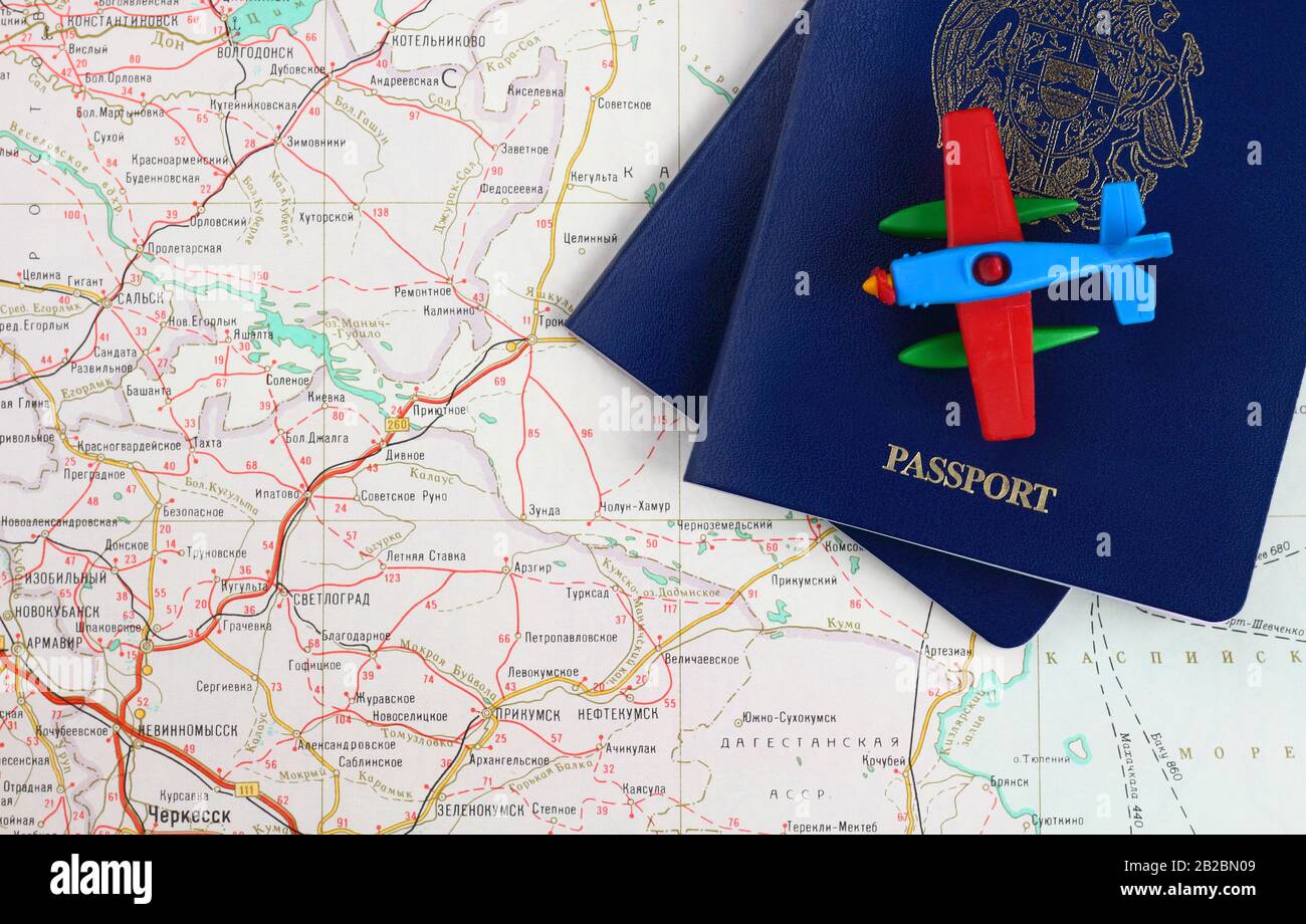 Travel concept. Pieces of two blue passports and toy airplane on a map. View from above. Stock Photo