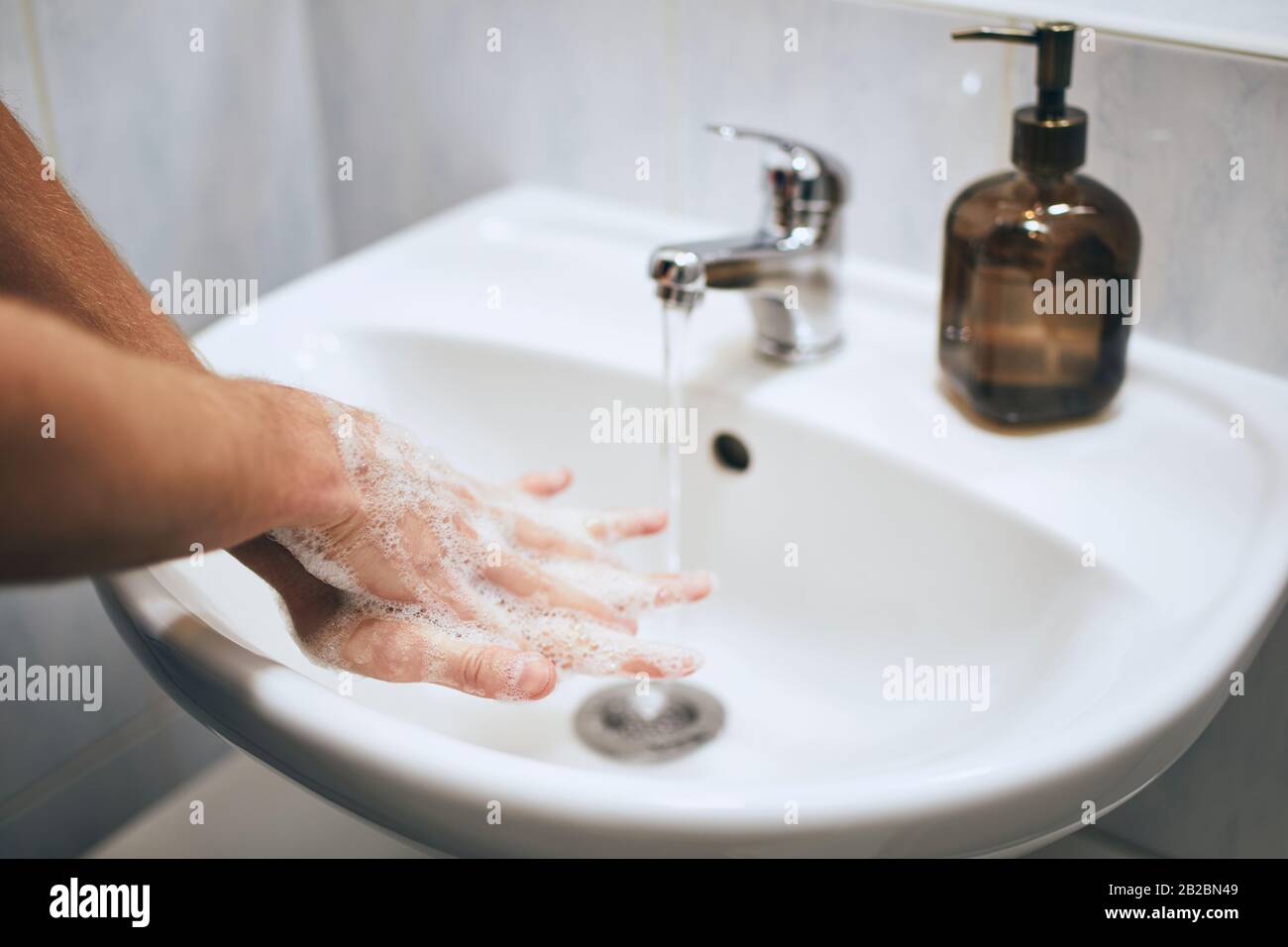Washing hands at home in bathroom. Healthy lifestyle, hygiene and prevention viral and bacterial diseases. Stock Photo