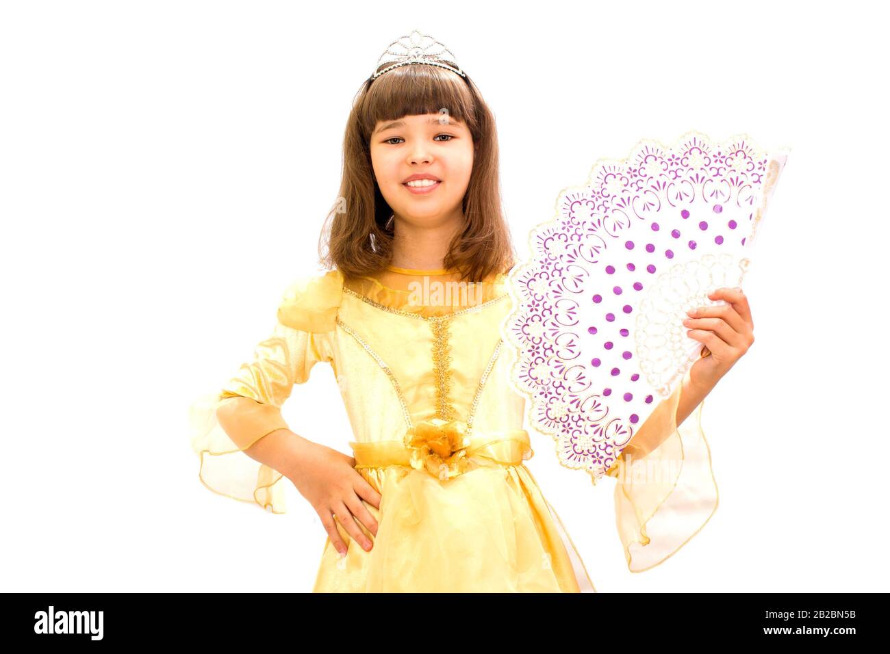 Girl in a beautiful ball gown with a fan in hand. On a white background. Stock Photo