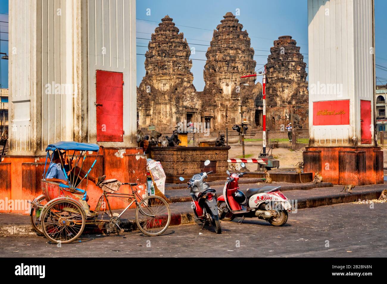 Rickshaw in front of Prang Sam Yod temple in Lopburi, Thailand Stock Photo