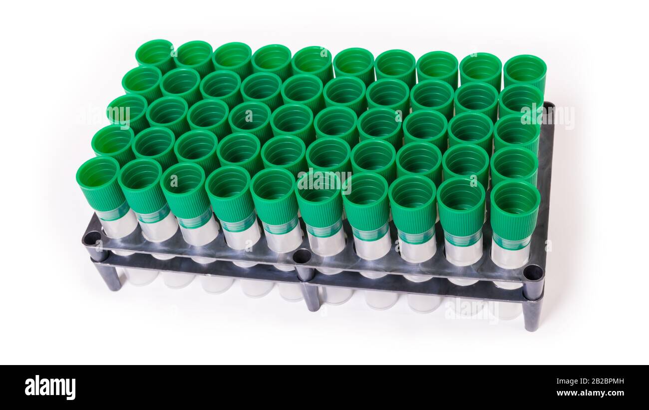 Empty laboratory test tubes in plastic rack. Medical sample tube and green screw cap. Sterile diagnostic equipment. Hospital, blood transfusion center. Stock Photo