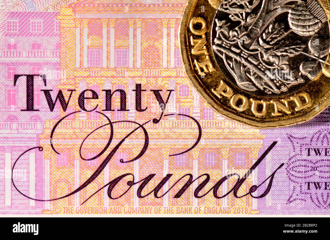 New British polymer £20 banknote (Feb 2020) and pound coin Stock Photo