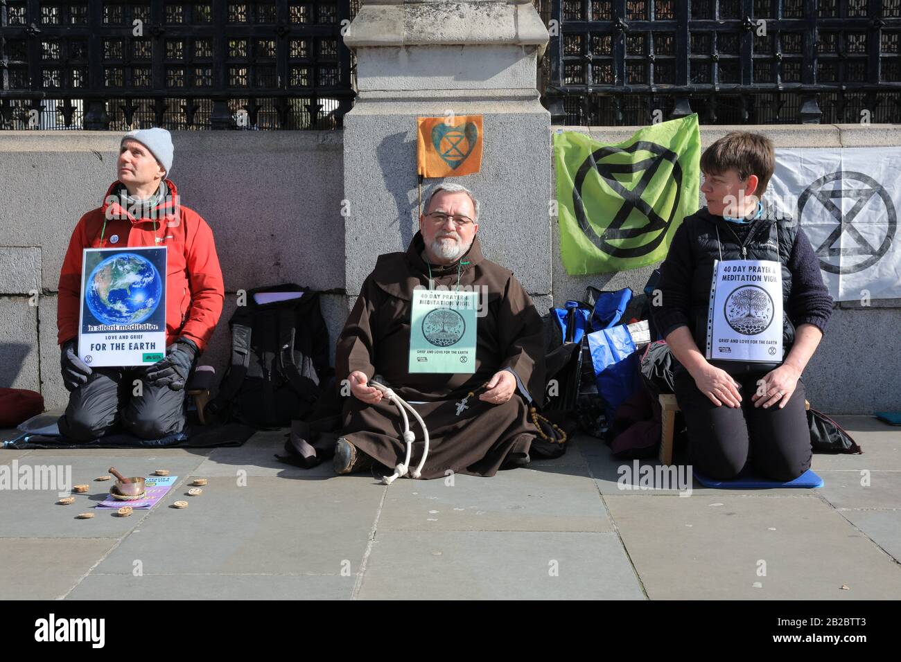 Westminster, London, UK. 2nd Mar, 2020. Extinction Rebellion (XR) have staged a meditation sit-down protest outside the gates to the House of Commons as part of their '40 Day Prayer and Meditation Vigil'. Christian Climate Action and Extinction Rebellion Faith Communities have joined forces during Lent for 40 days of Action for the planet. Credit: Imageplotter/Alamy Live News Stock Photo