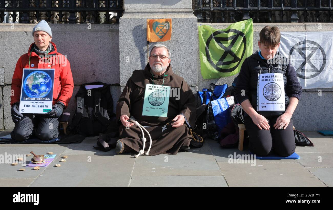 Westminster, London, UK. 2nd Mar, 2020. Extinction Rebellion (XR) have staged a meditation sit-down protest outside the gates to the House of Commons as part of their '40 Day Prayer and Meditation Vigil'. Christian Climate Action and Extinction Rebellion Faith Communities have joined forces during Lent for 40 days of Action for the planet. Credit: Imageplotter/Alamy Live News Stock Photo