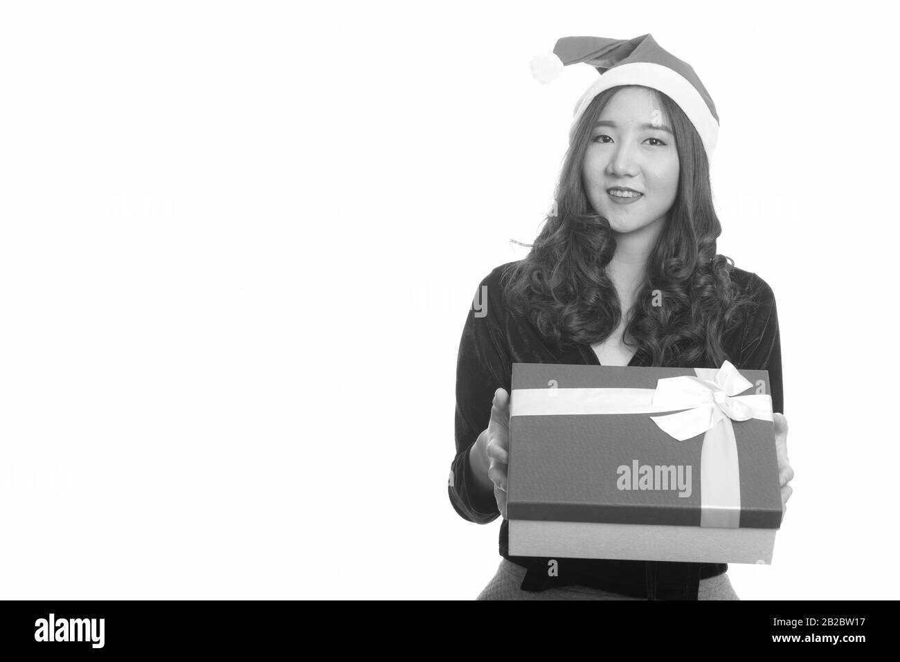 Young happy Asian woman giving gift box ready for Christmas Stock Photo ...