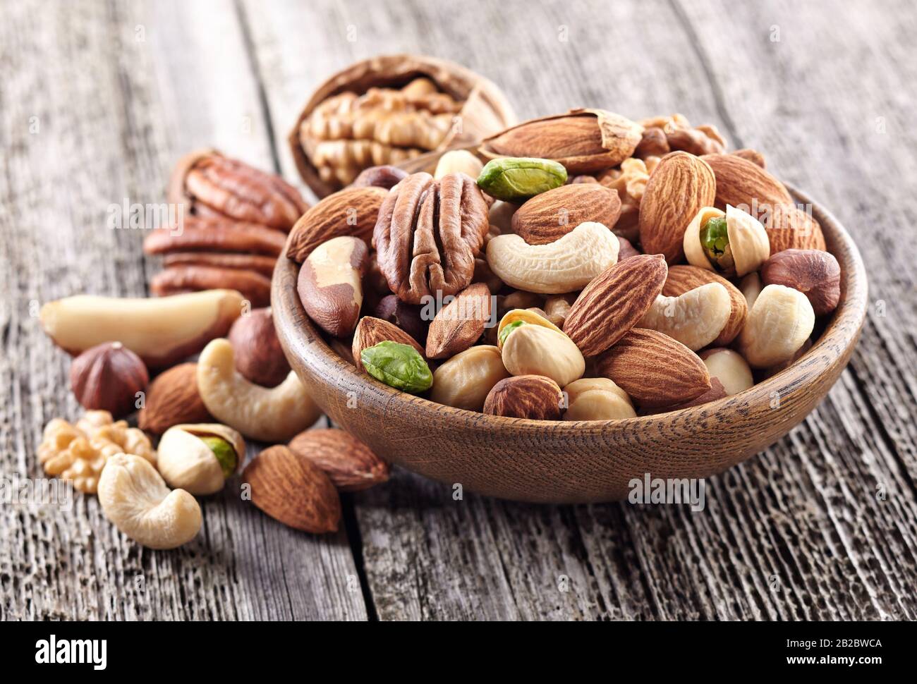 Nuts mix in a wooden plate Stock Photo
