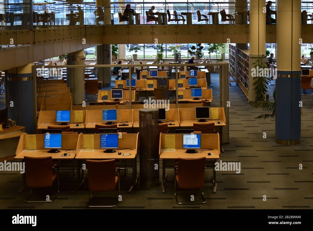 Large reading room with people in the library Stock Photo - Alamy