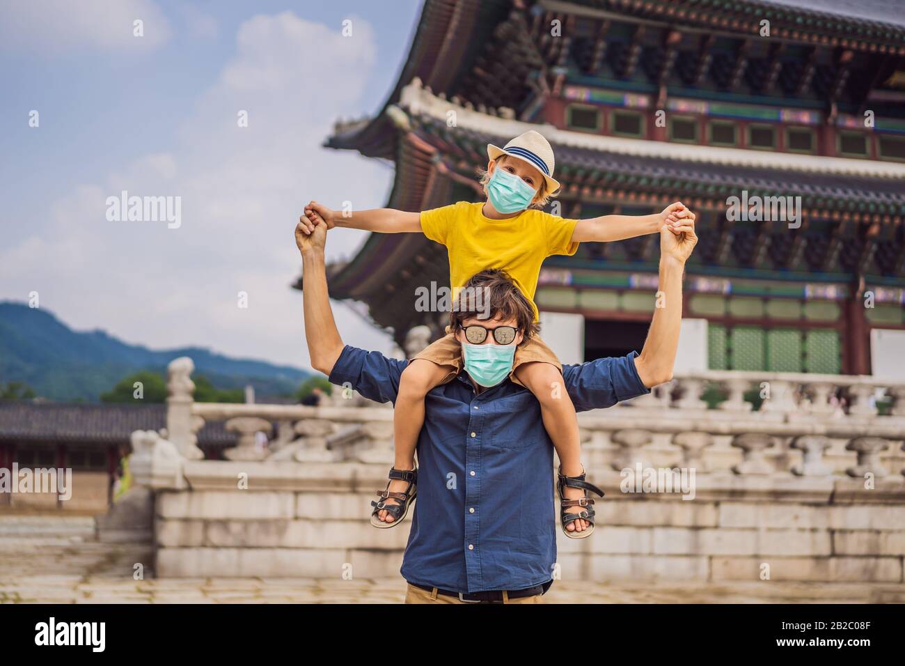Dad and son tourists in medical mask in Seoul, South Korea. Travel to