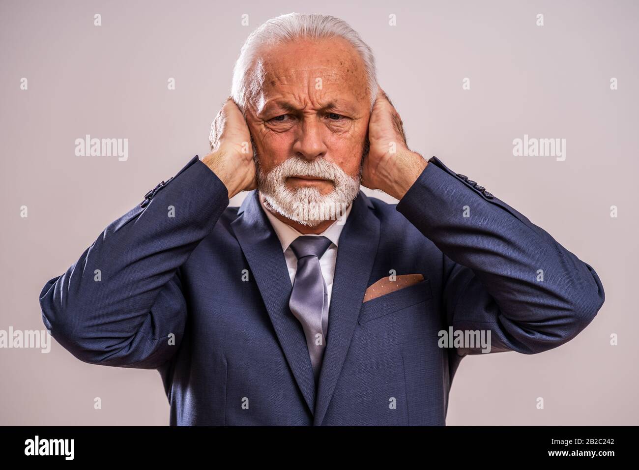 Portrait of senior businessman who is tired and frustrated. Stock Photo