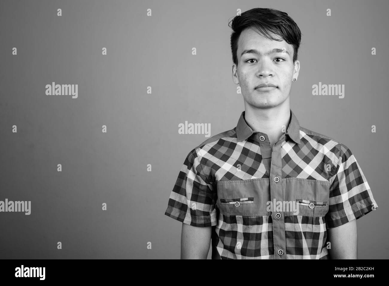 Portrait of young handsome Asian teenage boy Stock Photo