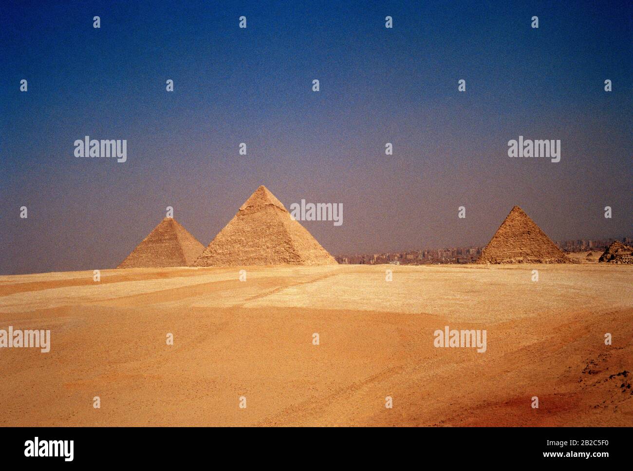 Travel - Pyramid of Khafre and The Great Pyramid Cheops or Khufu and Pyramid of Menkaure at the Pyramids of Giza in Cairo in Egypt in North Africa Stock Photo