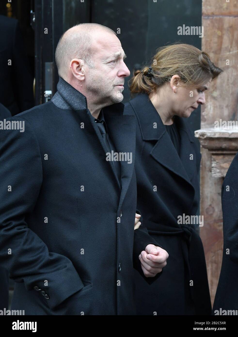 Munich, Germany. 02nd Mar, 2020. Heino Ferch, actor, and his wife Marie-Jeanette Ferch leave the church after the funeral service for director and cameraman Joseph Vilsmaier. Vilsmaier had died on 11 February at the age of 81. Credit: Tobias Hase/dpa/Alamy Live News Stock Photo