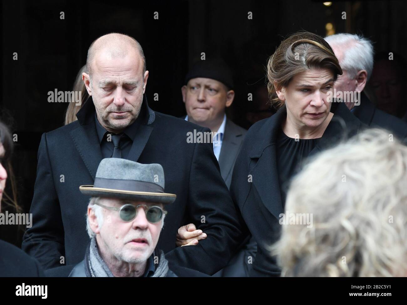 Munich, Germany. 02nd Mar, 2020. Heino Ferch, actor, and his wife Marie-Jeanette Ferch leave the church after the funeral service for director and cameraman Joseph Vilsmaier. Vilsmaier had died on 11 February at the age of 81. Credit: Tobias Hase/dpa/Alamy Live News Stock Photo