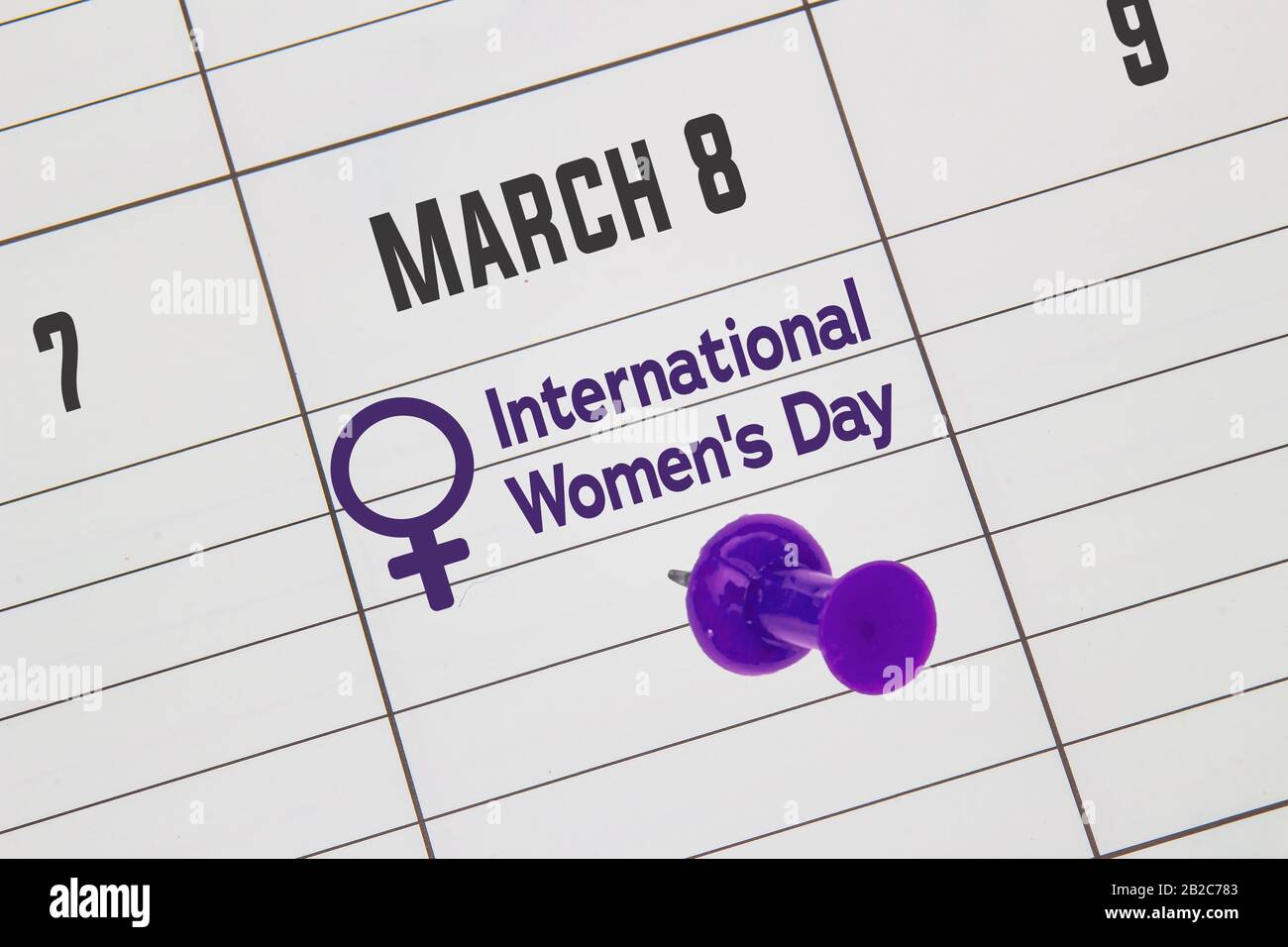 A close up to a Calendar on March 8 with the text: International Women's Day with a purple pin Stock Photo