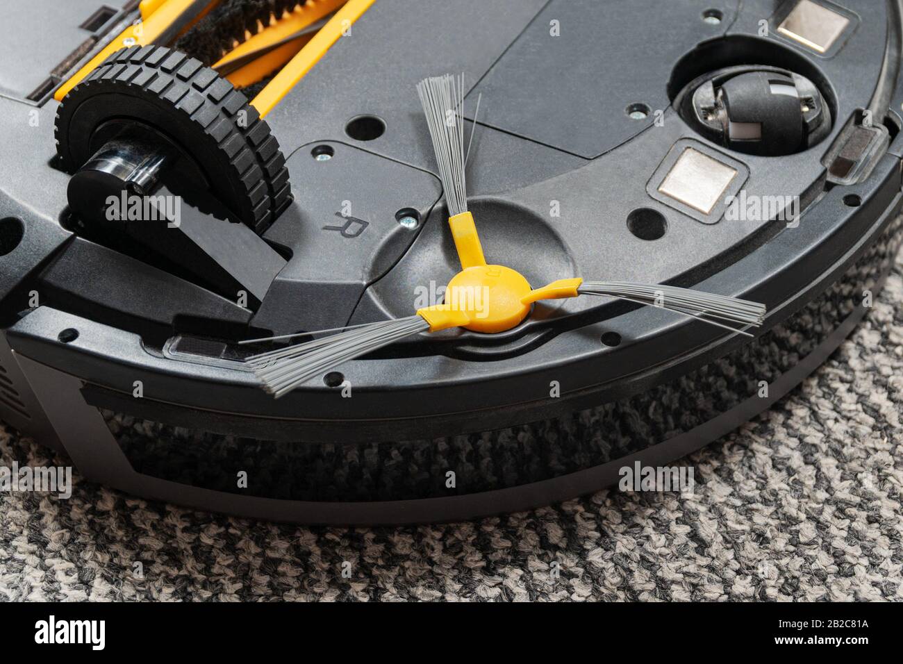 circular rotating brush of a vacuum cleaner robot, bottom view, close