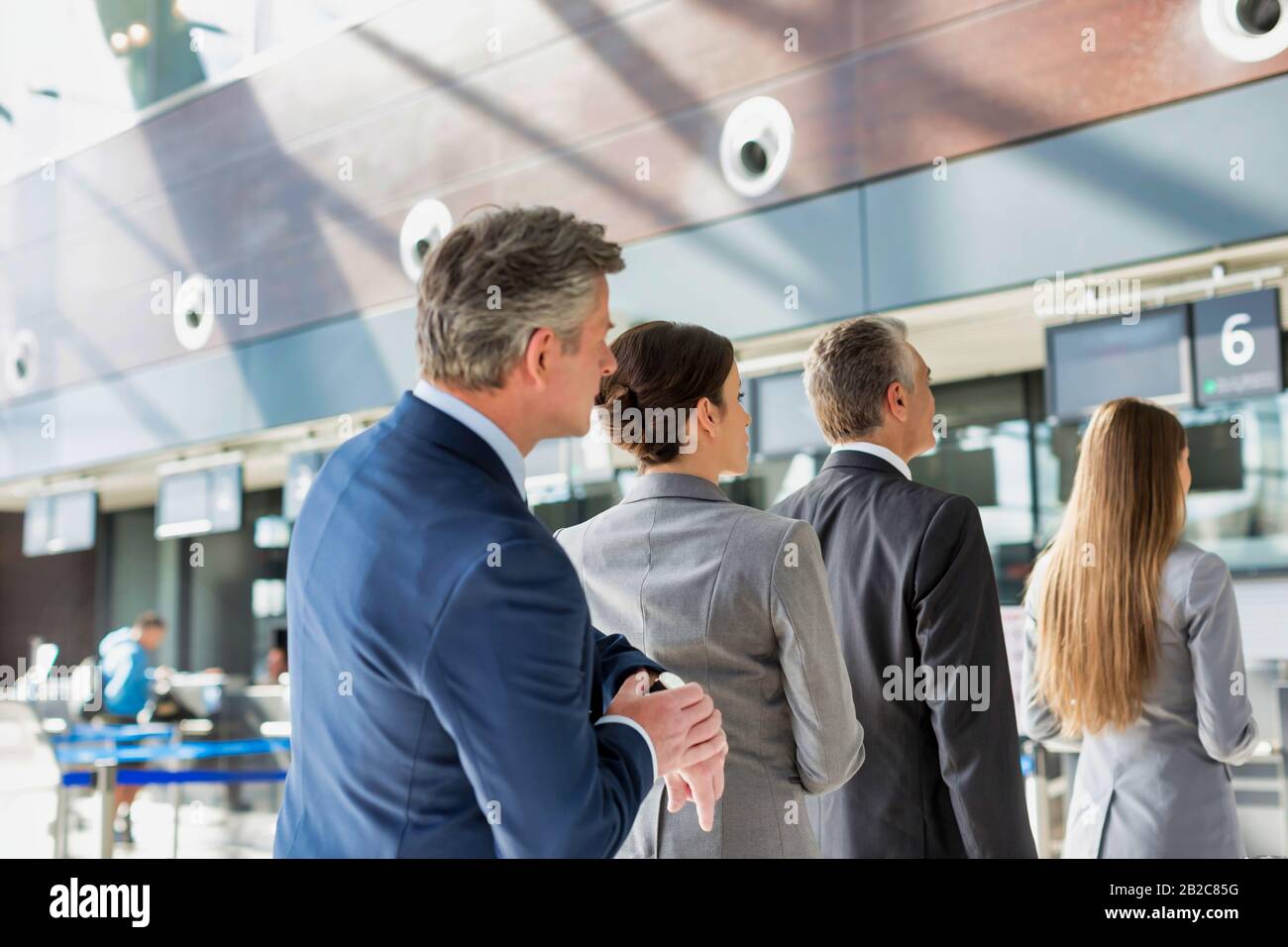 In Person Check In Business people queueing for check in at airport Stock Photo - Alamy