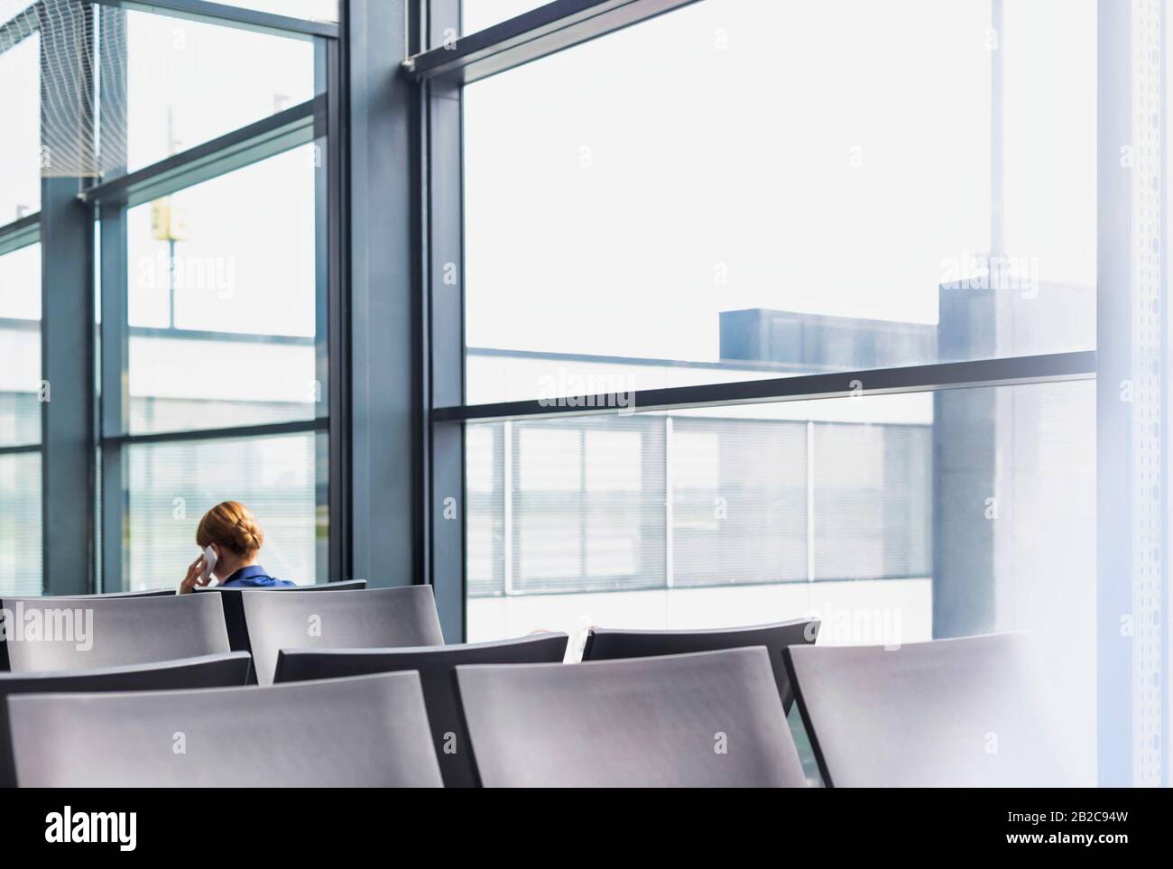 Photo of empty chairs on airport gate with lens flare Stock Photo