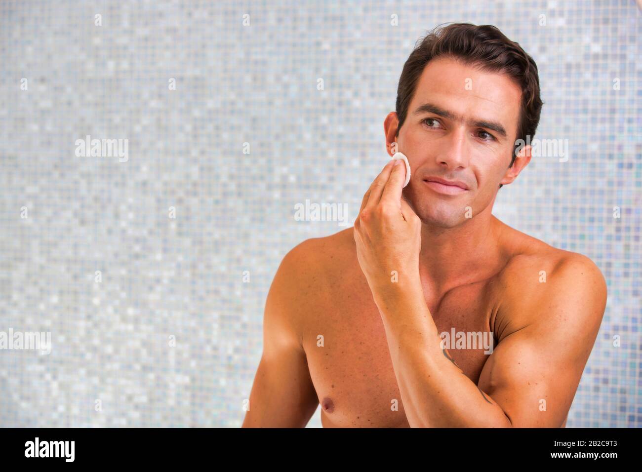 Attractive man performing skin care before bed Stock Photo Alamy