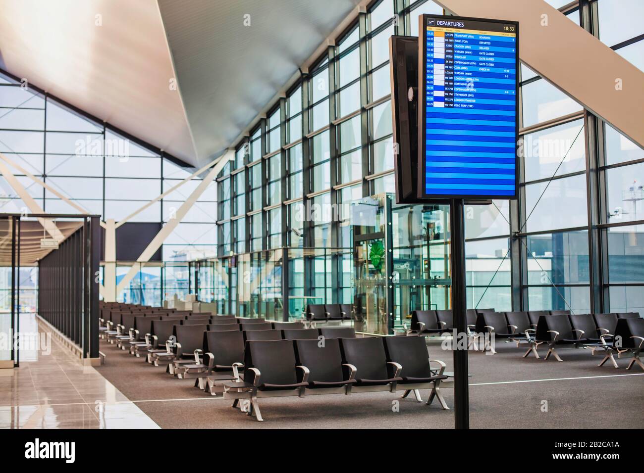 Flight display monitor in empty airport boarding gate Stock Photo