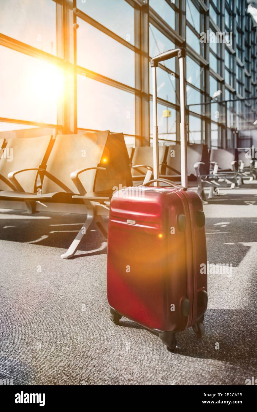 Photo of suitcase on empty boarding gate Stock Photo