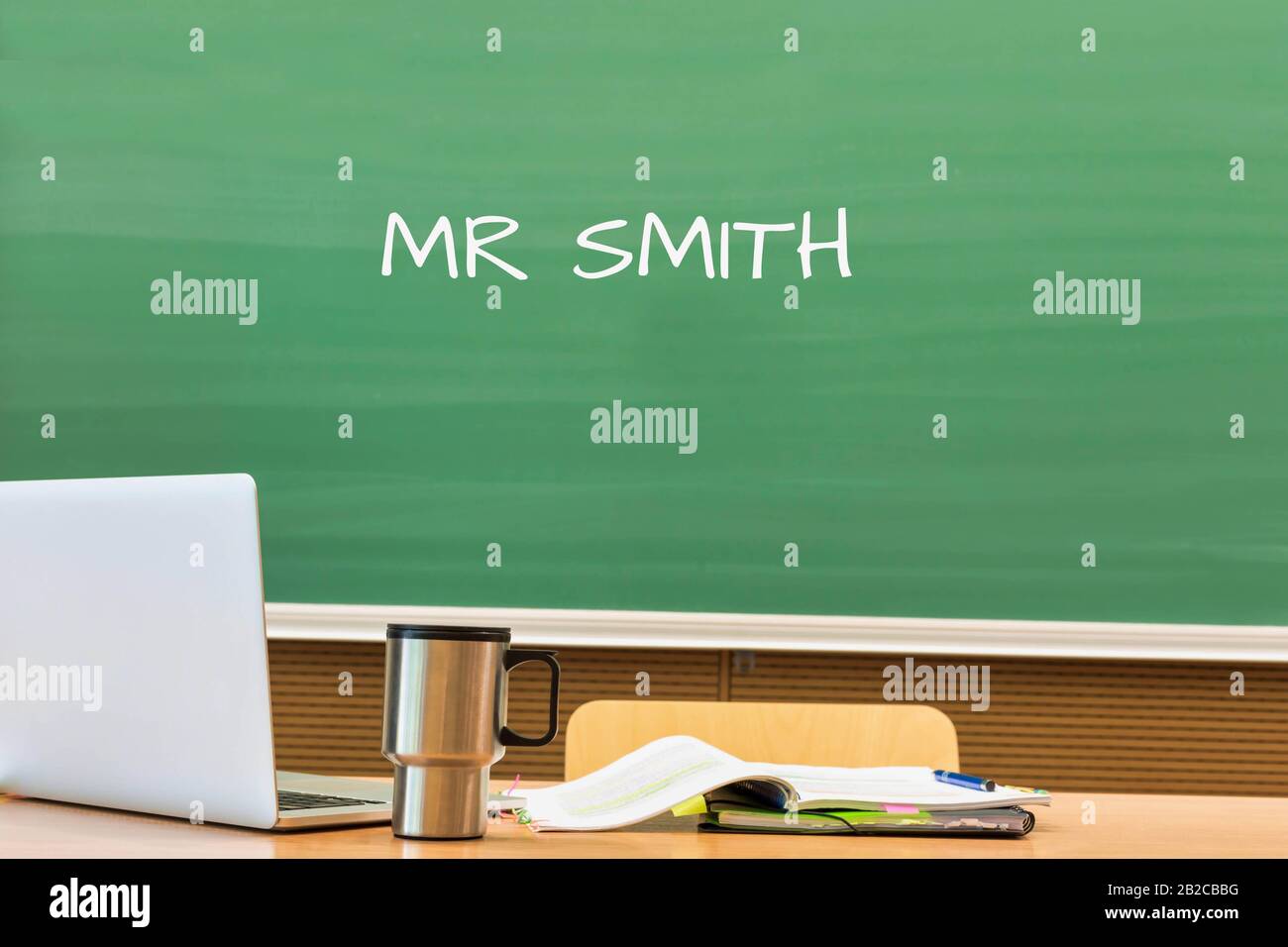 Photo of professor desk in classroom with Mr Smith name written in black board Stock Photo