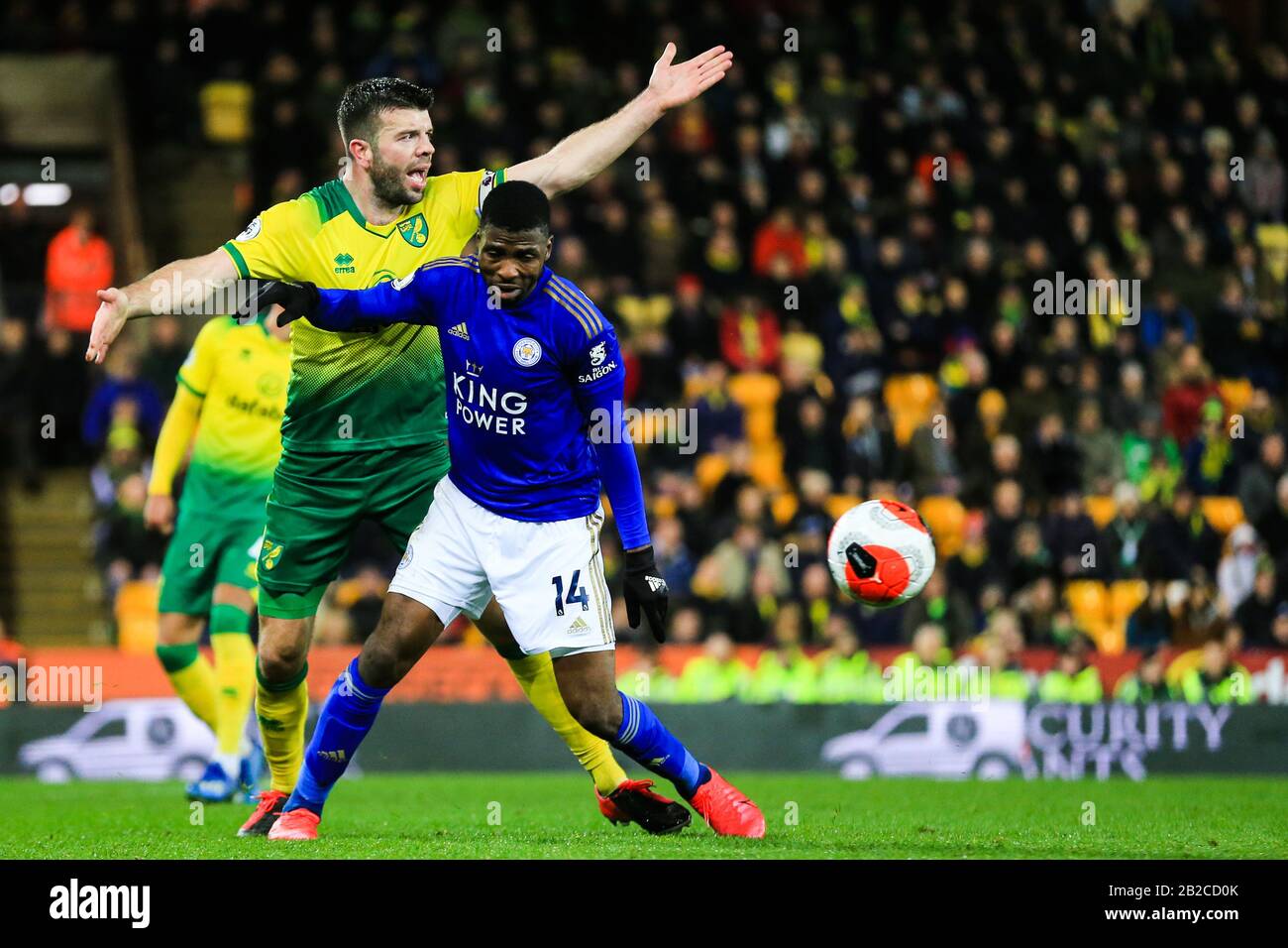 28th February 2020, Carrow Road, Norwich, England; Premier League, Norwich City v Leicester City : Grant Hanley (05) of Norwich City struggles with Kelechi Iheanacho (14) of Leicester City Stock Photo