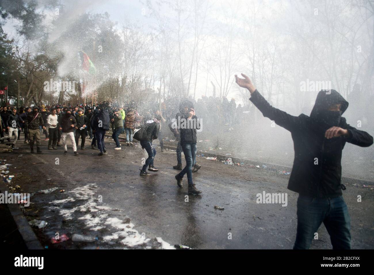 Istanbul. 2nd Mar, 2020. Illegal migrants are attacked by water cannons from Greek police at border zone in Edirne Province, Turkey, on March 1, 2020. TO GO WITH 'Greek police fire tear gas, rubber bullets against refugees at border zone in Turkey' Credit: Xinhua/Alamy Live News Stock Photo