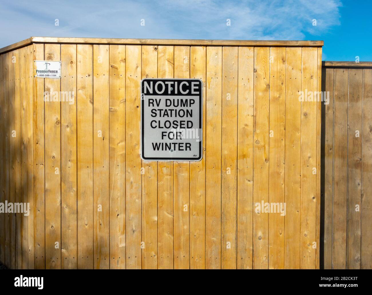 Notice Sign RV Dump Station Closed for Winter Sign on wood fence Stock Photo