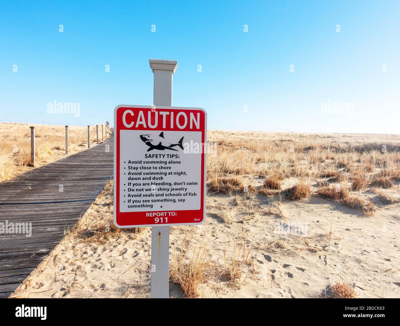 Caution Shark Warning Sign at Scusset Beach, Sagamore Cape Cod, Massachusetts USA Stock Photo