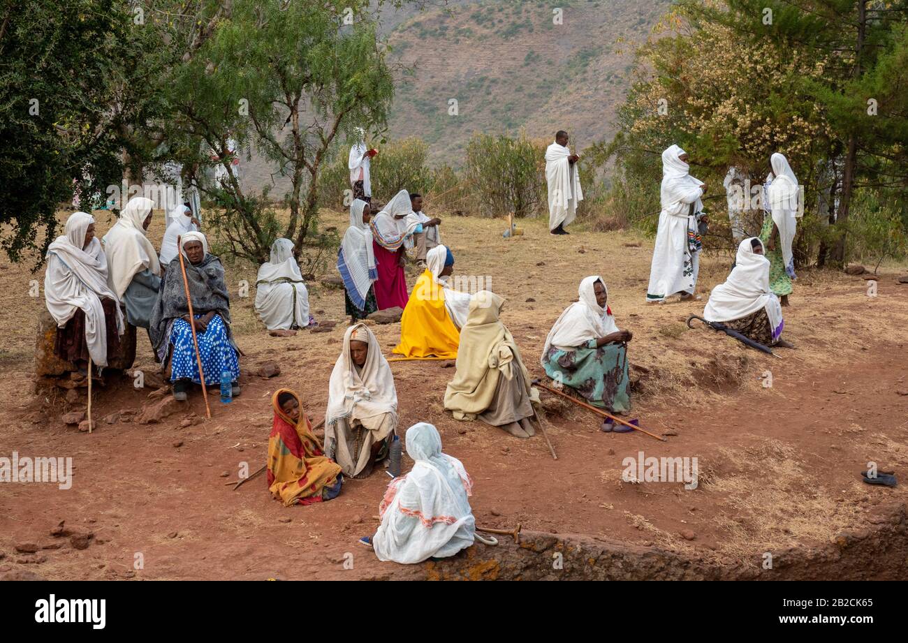 People gathering for prayer near Saint George stone church, one of eleven rock-hewn monolithic churches in Lalibela, a city in the Amhara Region Stock Photo