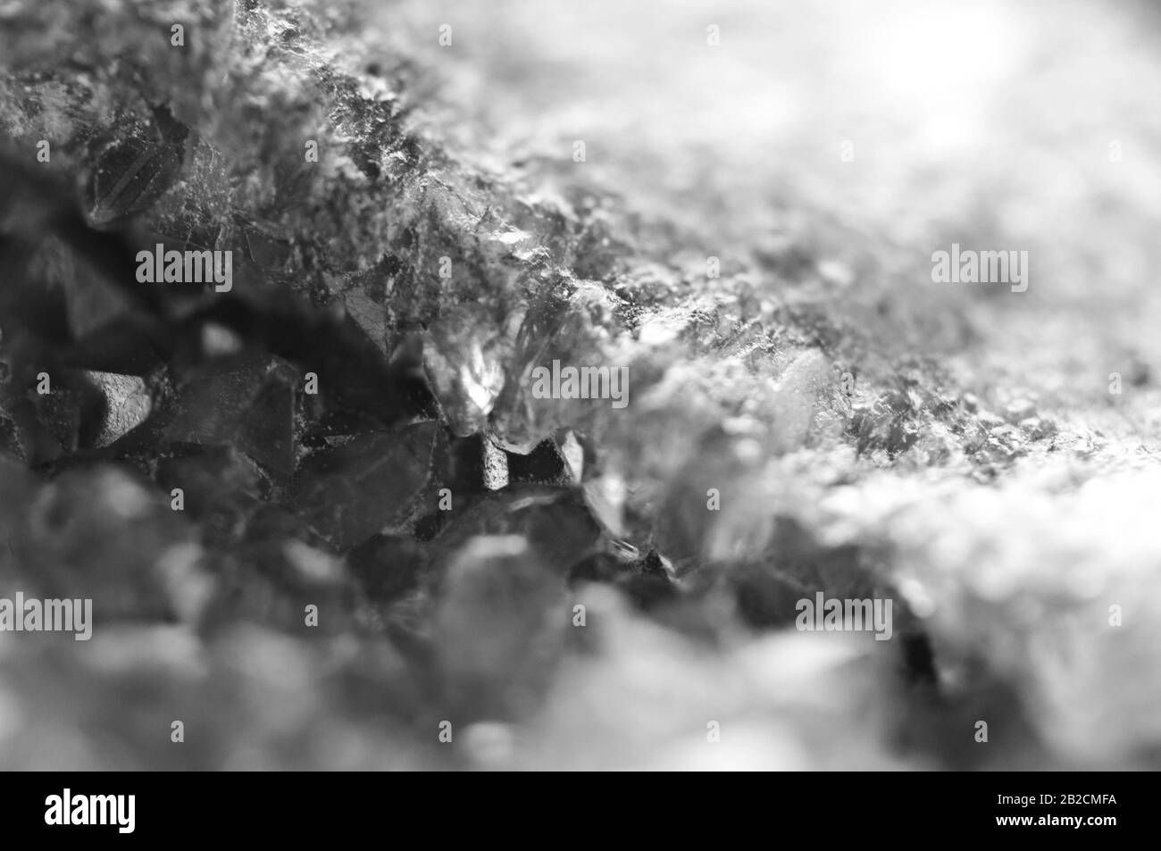 Black and white photograph of the structure of the surface of crystals. Close-up. Blurred background Stock Photo