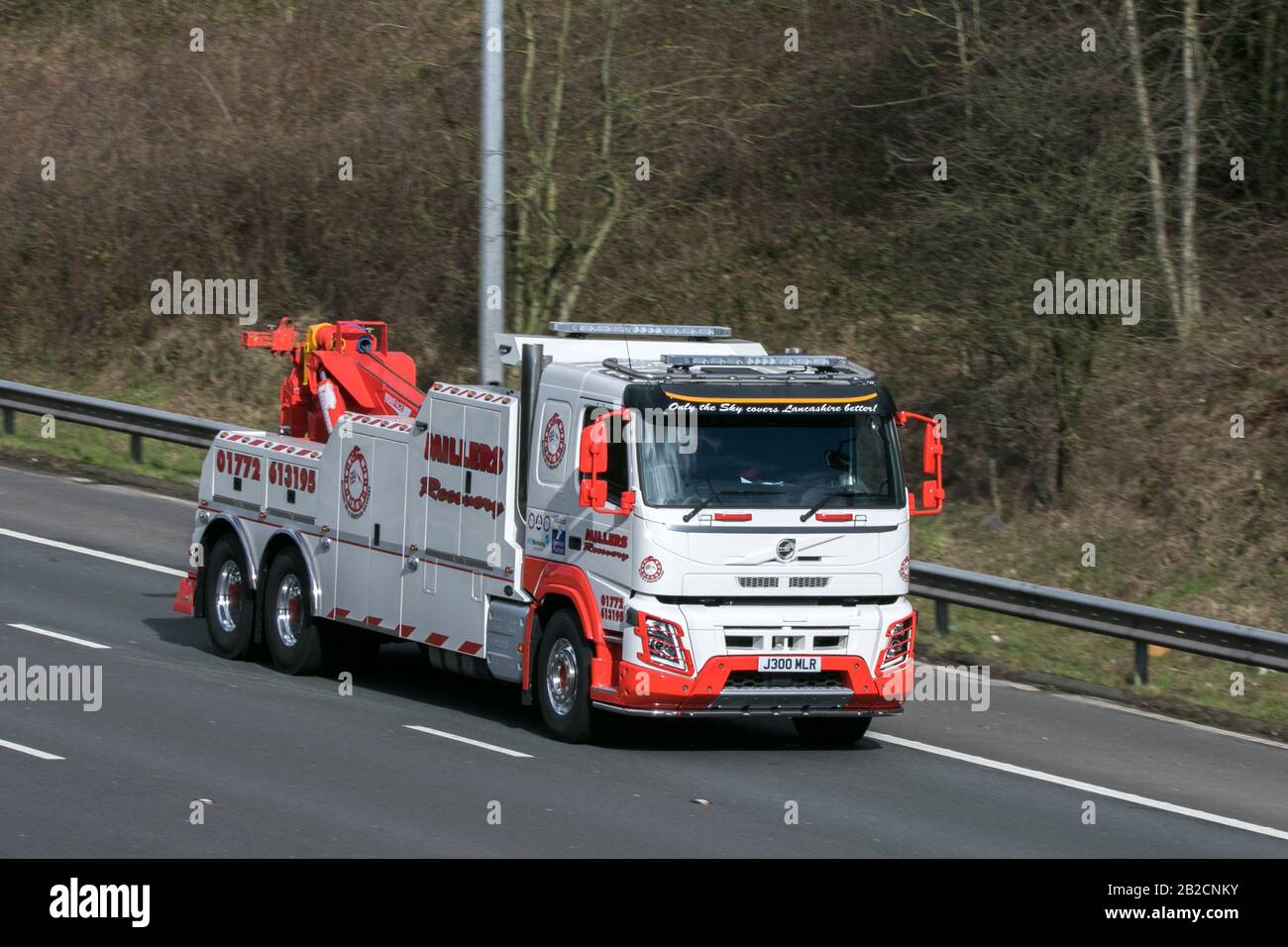 Volvo Globetrotter Millers HGV vehicle recovery truck driving on the M6 motorway near Preston in Lancashire, UK Stock Photo