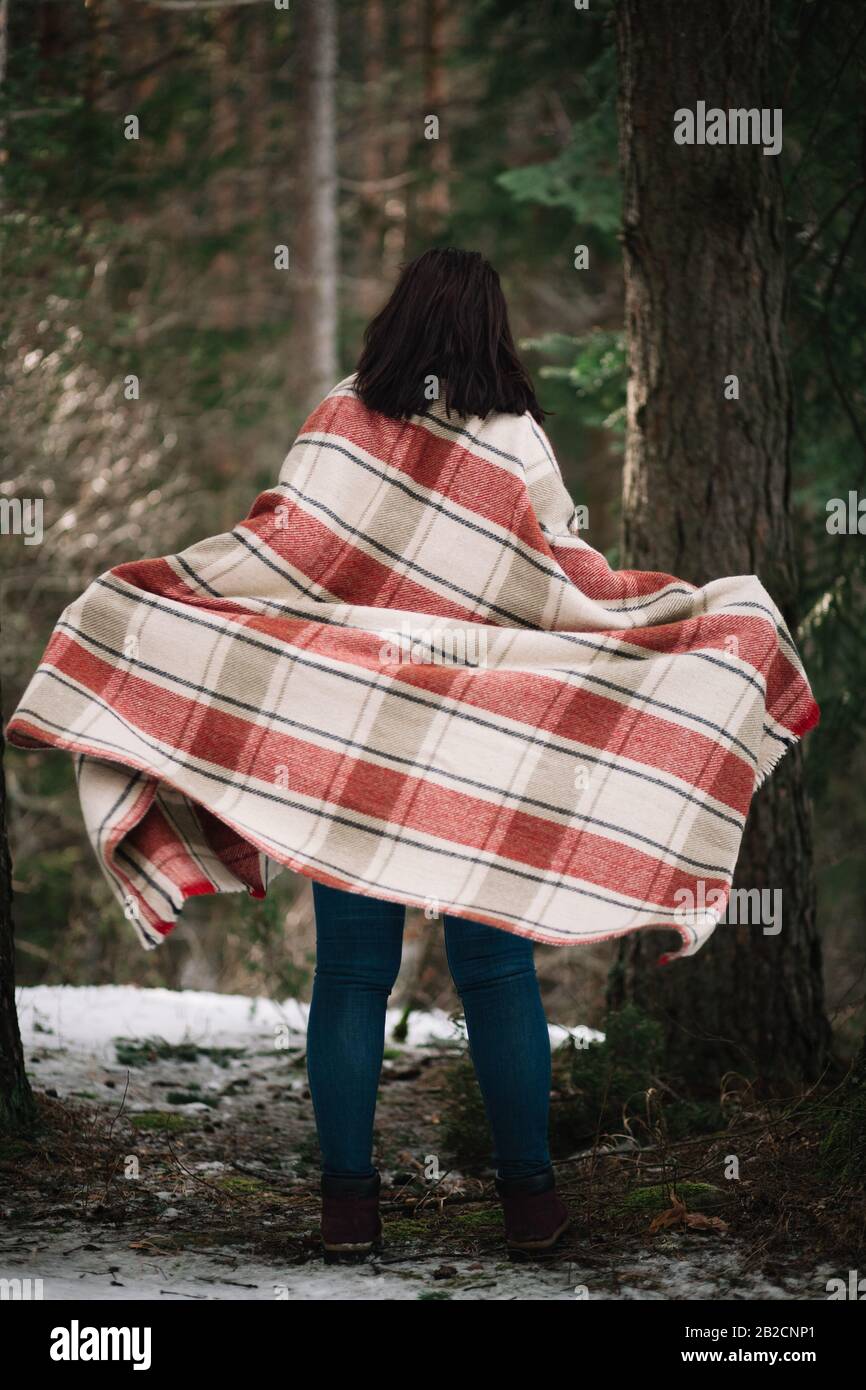 Back of a girl covered with blanket. woman covered with a